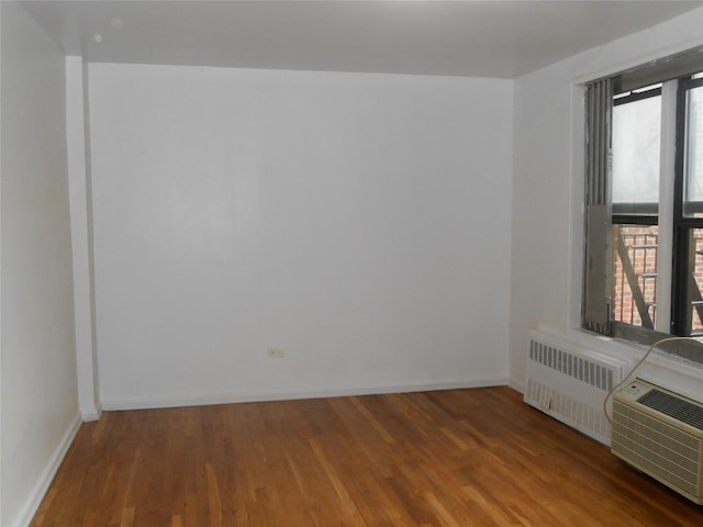 131-11KEWGARDENS Kew Gardens Rd Unit 4D, Richmond Hill, NY 11418 - spare room with radiator, plenty of natural light, and wood finished floors