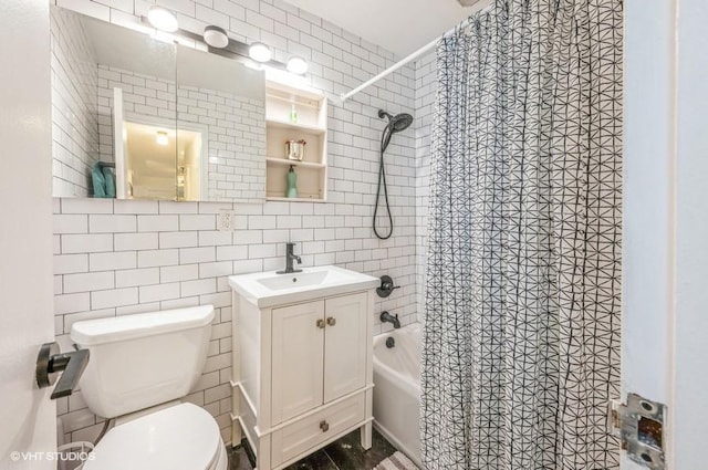 full bath featuring tile walls, toilet, shower / bath combination with curtain, vanity, and backsplash