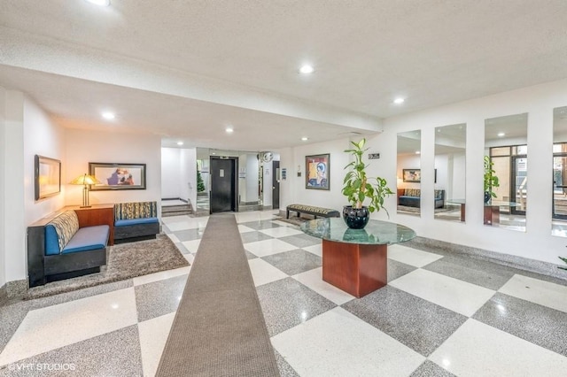 building lobby with recessed lighting and stairs