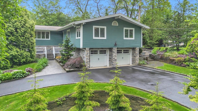 7 Tuxedo Dr, Melville, NY 11747 - view of front of property with stone siding, asphalt driveway, and an attached garage
