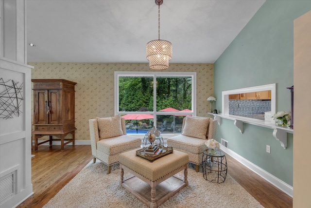 7 Tuxedo Dr, Melville, NY 11747 - living room with wood finished floors, baseboards, wallpapered walls, and vaulted ceiling