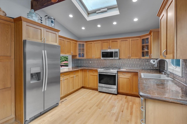 7 Tuxedo Dr, Melville, NY 11747 - kitchen with appliances with stainless steel finishes, a sink, a skylight, backsplash, and vaulted ceiling