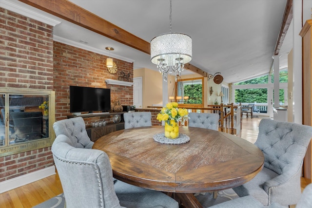 7 Tuxedo Dr, Melville, NY 11747 - dining area with a brick fireplace, wood finished floors, beamed ceiling, a chandelier, and brick wall