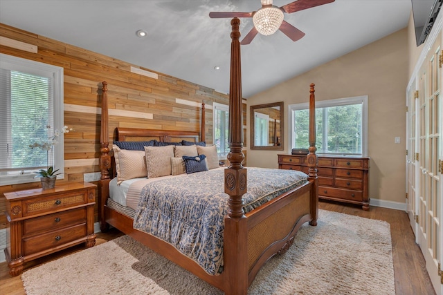 7 Tuxedo Dr, Melville, NY 11747 - bedroom featuring wooden walls, lofted ceiling, recessed lighting, wood finished floors, and ceiling fan