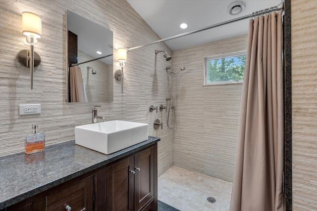 7 Tuxedo Dr, Melville, NY 11747 - full bathroom with tiled shower, vanity, lofted ceiling, tile walls, and decorative backsplash