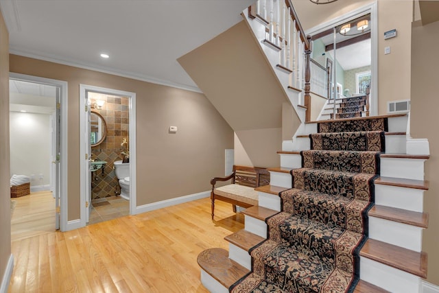 7 Tuxedo Dr, Melville, NY 11747 - stairway featuring wood finished floors, crown molding, baseboards, and recessed lighting