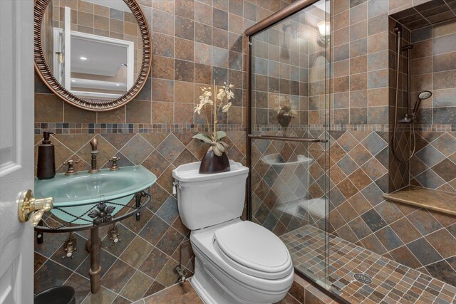 7 Tuxedo Dr, Melville, NY 11747 - bathroom featuring toilet, a shower stall, tile walls, and a sink