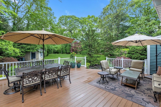 7 Tuxedo Dr, Melville, NY 11747 - wooden terrace with outdoor dining area, view of wooded area, and a lawn
