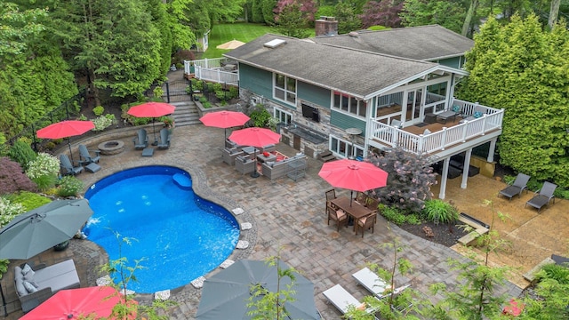 7 Tuxedo Dr, Melville, NY 11747 - swimming pool with outdoor dining space, a deck, stairs, and a patio