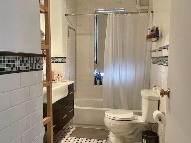 305 W 18th St Unit 1C, New York Manhattan, NY 10011 - full bath featuring tile walls, shower / bath combo with shower curtain, toilet, tile patterned floors, and vanity