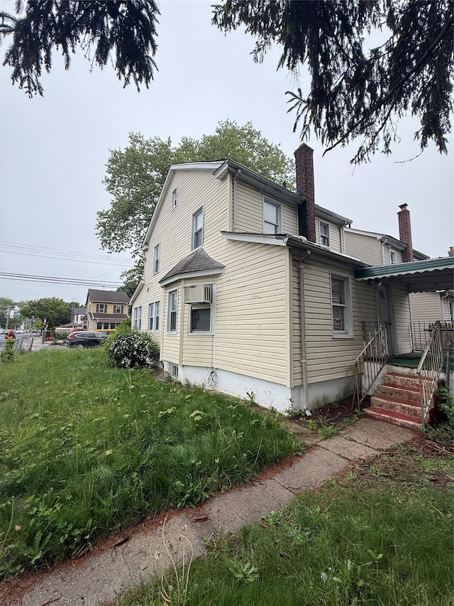 114-02 208th St, Saint Albans, NY 11411 - view of property exterior with a chimney