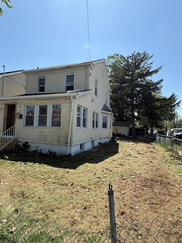 114-02 208th St, Saint Albans, NY 11411 - view of home's exterior featuring fence and entry steps
