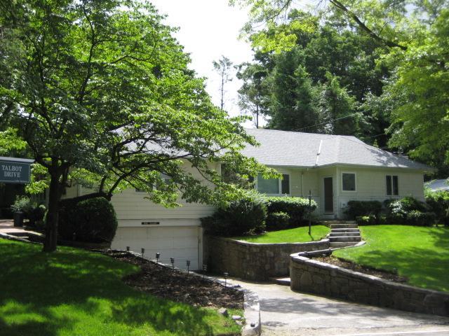 ranch-style home with an attached garage and a front yard