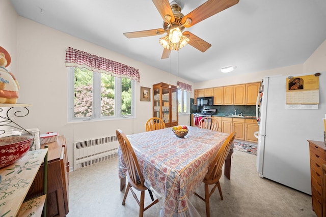2816 215th Pl, Bayside, NY 11360 - dining area with radiator heating unit, ceiling fan, and light carpet