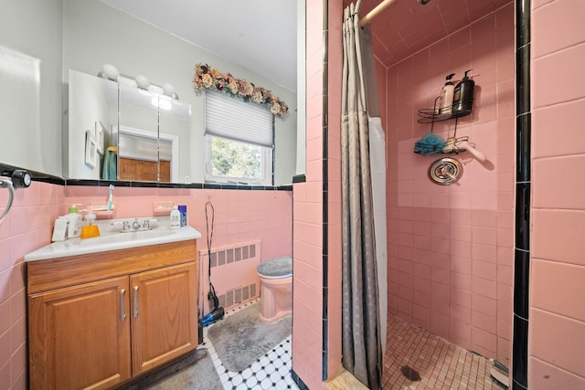 2816 215th Pl, Bayside, NY 11360 - bathroom with radiator heating unit, a shower stall, tile walls, vanity, and toilet