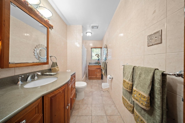2816 215th Pl, Bayside, NY 11360 - bathroom featuring tile walls, vanity, toilet, tile patterned floors, and a shower