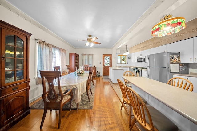 2816 215th Pl, Bayside, NY 11360 - dining area featuring light wood-style floors, crown molding, and a ceiling fan