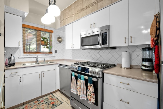 2816 215th Pl, Bayside, NY 11360 - kitchen featuring appliances with stainless steel finishes, a sink, backsplash, and light countertops