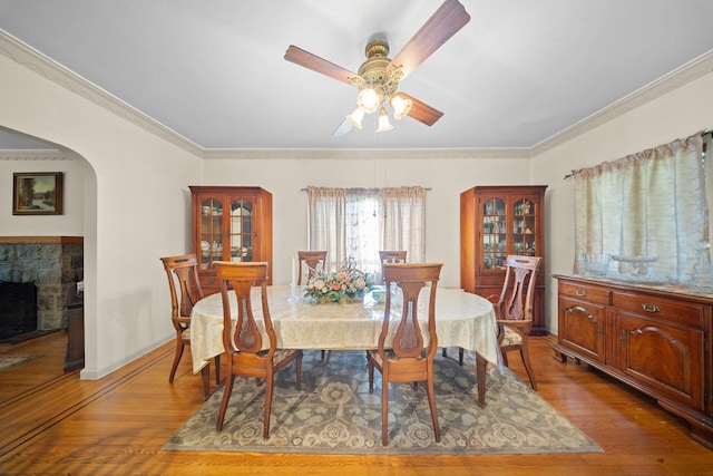 2816 215th Pl, Bayside, NY 11360 - dining room with wood finished floors, crown molding, ceiling fan, a fireplace, and baseboards