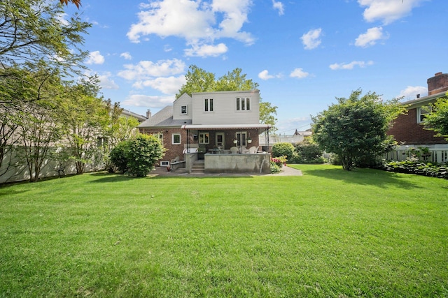 2816 215th Pl, Bayside, NY 11360 - rear view of property with brick siding and a yard