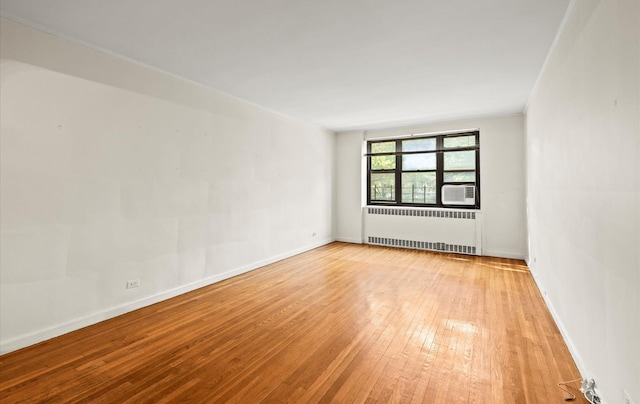 67-71 Yellowstone Blvd Unit 3-L, Forest Hills, NY 11375 - empty room featuring radiator, light wood-style flooring, baseboards, and cooling unit