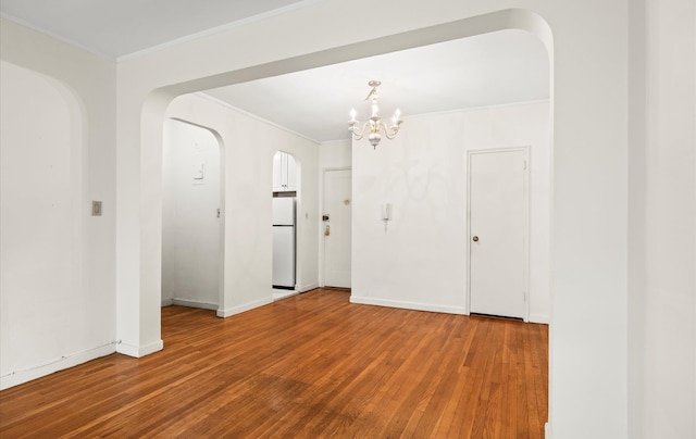 67-71 Yellowstone Blvd Unit 3-L, Forest Hills, NY 11375 - empty room featuring hardwood / wood-style floors, ornamental molding, a chandelier, arched walkways, and baseboards