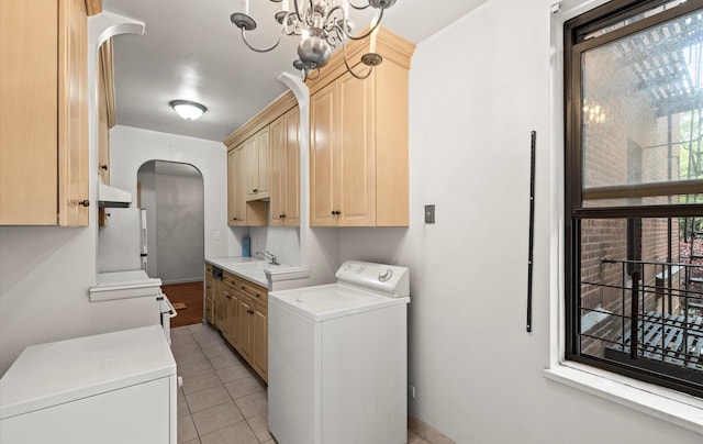 67-71 Yellowstone Blvd Unit 3-L, Forest Hills, NY 11375 - laundry room with washer / dryer, cabinet space, arched walkways, light tile patterned floors, and a chandelier