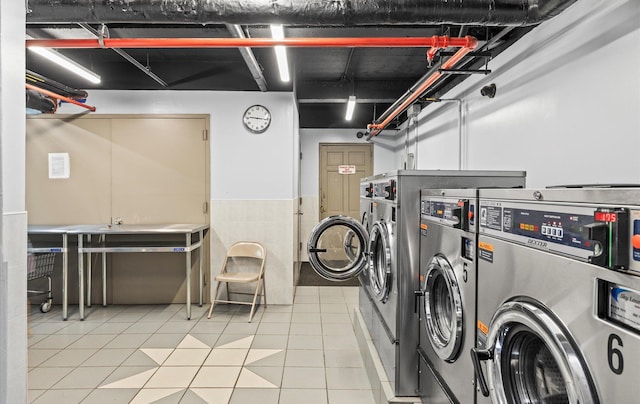67-71 Yellowstone Blvd Unit 3-L, Forest Hills, NY 11375 - shared laundry room with washer and clothes dryer, stacked washing machine and dryer, wainscoting, and light tile patterned floors