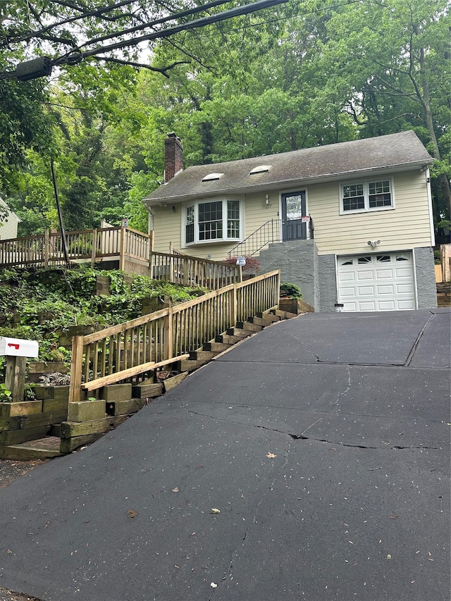 107 Norwood Ave, Northport, NY 11768 - ranch-style home with a chimney, concrete driveway, and an attached garage