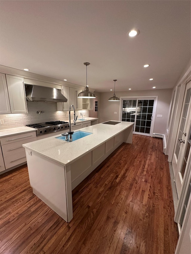 107 Norwood Ave, Northport, NY 11768 - kitchen with wall chimney exhaust hood, a sink, stove, a kitchen island with sink, and tasteful backsplash