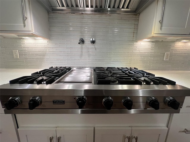 107 Norwood Ave, Northport, NY 11768 - kitchen featuring backsplash, exhaust hood, light countertops, and stainless steel gas stovetop