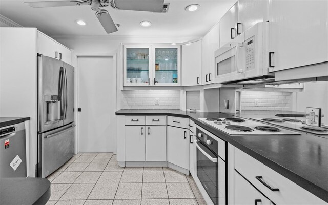 94 Stonehurst Ln, Dix Hills, NY 11746 - kitchen featuring stainless steel appliances, recessed lighting, dark countertops, a ceiling fan, and white cabinets