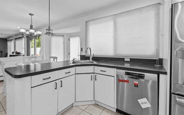 94 Stonehurst Ln, Dix Hills, NY 11746 - kitchen featuring stainless steel appliances, a sink, ornamental molding, dark countertops, and a peninsula