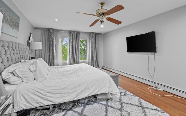 94 Stonehurst Ln, Dix Hills, NY 11746 - bedroom featuring baseboard heating, wood finished floors, recessed lighting, and a ceiling fan