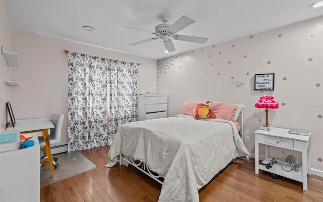 94 Stonehurst Ln, Dix Hills, NY 11746 - bedroom with wood-type flooring, baseboard heating, and a ceiling fan