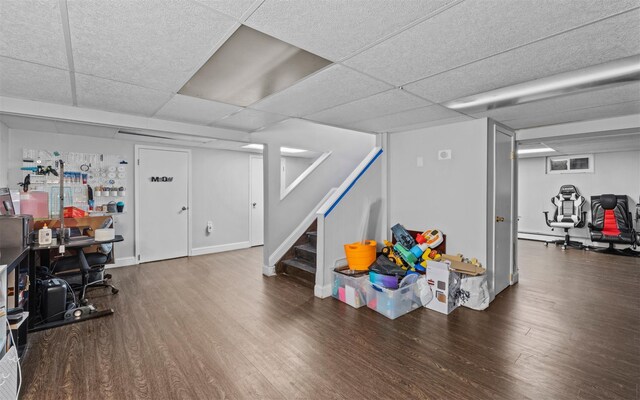 94 Stonehurst Ln, Dix Hills, NY 11746 - finished below grade area with wood finished floors, a drop ceiling, stairs, and a baseboard heating unit