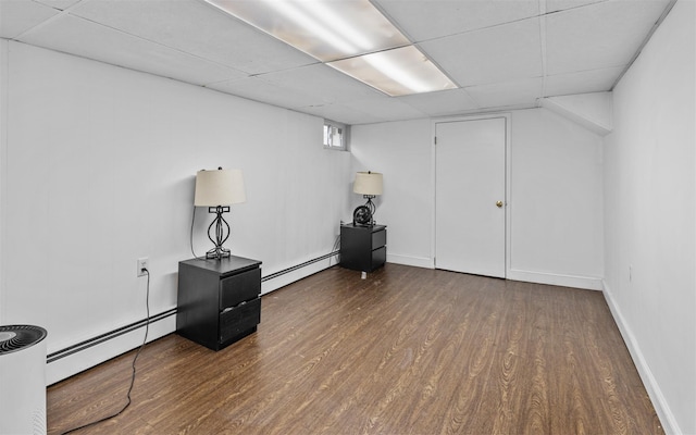 94 Stonehurst Ln, Dix Hills, NY 11746 - basement featuring a baseboard radiator, wood finished floors, a drop ceiling, and baseboards
