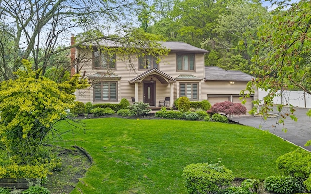 94 Stonehurst Ln, Dix Hills, NY 11746 - view of front facade featuring a chimney, a front yard, asphalt driveway, and a garage