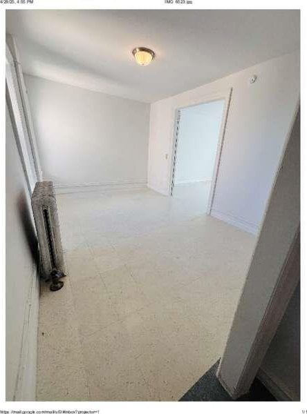 1898 Longfellow Ave Unit E4, Bronx, NY 10460 - spare room featuring radiator, tile patterned floors, and baseboards