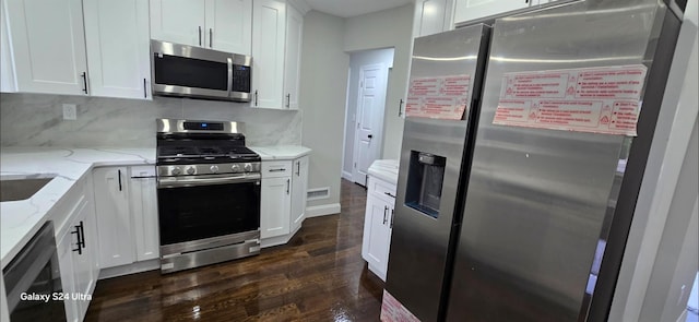 151 Boylston St, Hempstead, NY 11550 - kitchen with appliances with stainless steel finishes, dark wood-style flooring, white cabinets, and decorative backsplash