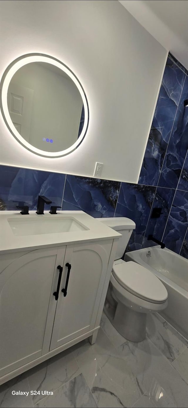 151 Boylston St, Hempstead, NY 11550 - full bathroom featuring tile walls, marble finish flooring, vanity, toilet, and wainscoting