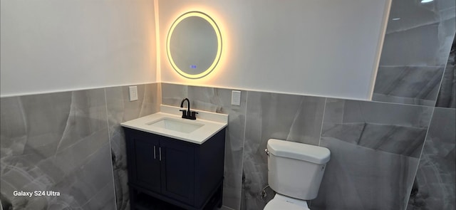 151 Boylston St, Hempstead, NY 11550 - bathroom with tile walls, vanity, toilet, and a wainscoted wall