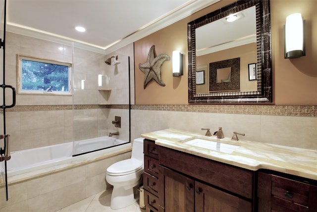 full bath with tile walls, crown molding, tile patterned floors, tiled shower / bath combo, and toilet