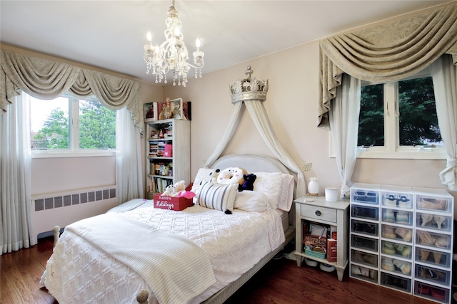 bedroom featuring radiator heating unit, wood finished floors, and a chandelier