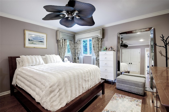 bedroom featuring ornamental molding, dark wood finished floors, ceiling fan, and baseboards