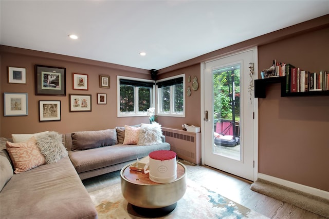 living room with radiator heating unit, recessed lighting, wood finished floors, and baseboards