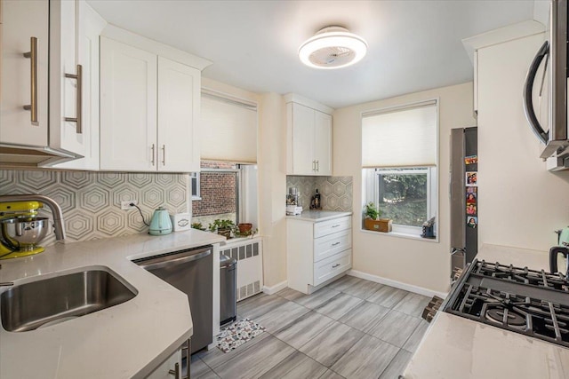 211-65 23rd Ave Unit 1B, Bayside, NY 11360 - kitchen featuring dishwasher, white cabinetry, backsplash, fridge, and a sink