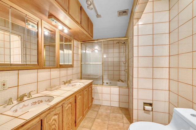 3893 Rte 82, Millbrook, NY 12545 - bathroom featuring tile patterned floors, toilet, tile walls, tiled shower / bath, and double vanity