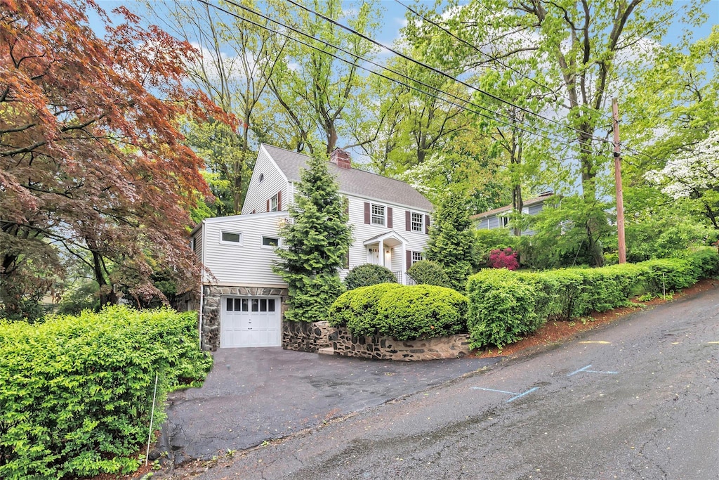 3 Richmond Hill Rd, Call Listing Agent, CT 06854 - view of property exterior with a chimney, an attached garage, driveway, stone siding, and a shingled roof
