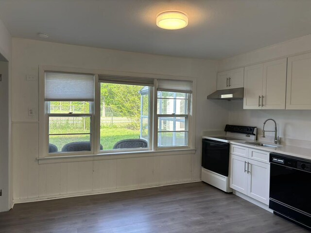2333 Beech St, Wantagh, NY 11793 - kitchen featuring black dishwasher, a sink, under cabinet range hood, range with electric cooktop, and white cabinetry